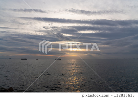 Sunset Ocean Ships; Coastal View; Evening Seascape: Tranquil ocean sunset with distant ships, coastal scene. 132935633