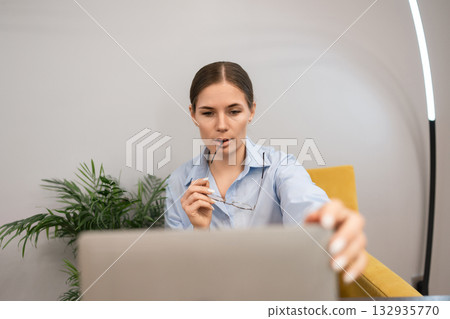Businesswoman laptop concentration modern female entrepreneur considering data while working remotely Businesswoman laptop concentration modern female entrepreneur considering data while working remotely 132935770