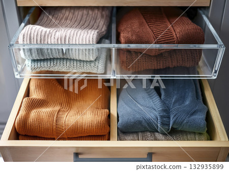 Dresser, clear case, and knit sweater 132935899