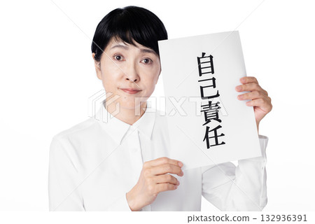 Senior woman looking at camera and holding a piece of paper that says "personal responsibility" Senior woman looking at camera and holding a piece of paper that says "personal responsibility" 132936391