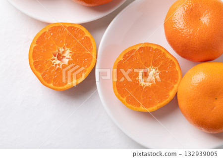 Mandarin orange fruit on white plate with white background, Top view 132939005