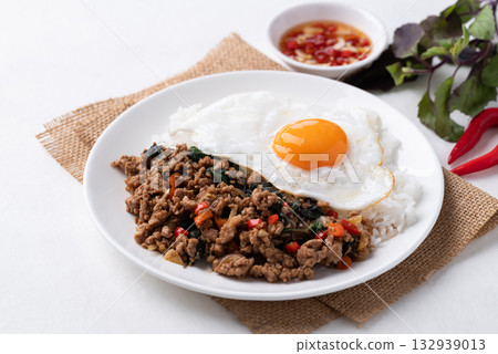 Thai food, Stir fried holy basil with minced pork with cooked rice and fried egg on top Thai food, Stir fried holy basil with minced pork with cooked rice and fried egg on top 132939013