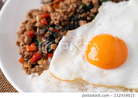 Thai food, Stir fried holy basil with minced pork with cooked rice and fried egg on top, Close up Thai food, Stir fried holy basil with minced pork with cooked rice and fried egg on top, Close up 132939015