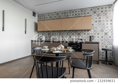 Modern Kitchen Interior with Patterned Tile Wall and Tea Set Modern Kitchen Interior with Patterned Tile Wall and Tea Set 132939631