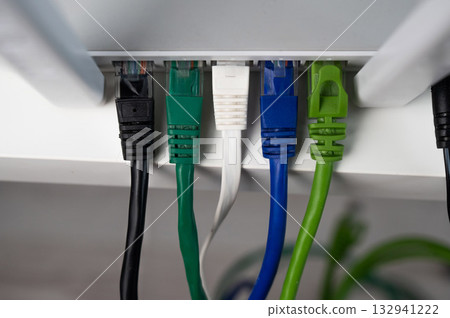 Colorful Ethernet Cables Connected to a Router.  132941222