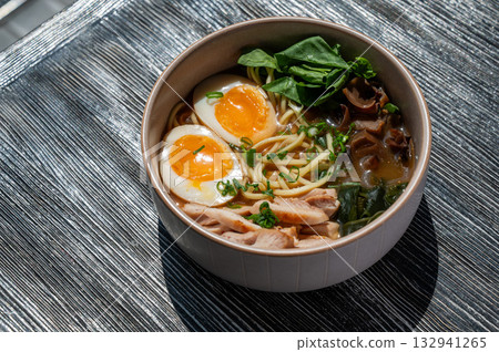 Ramen soup in cafe on wooden table. Ramen soup in cafe on wooden table. 132941265