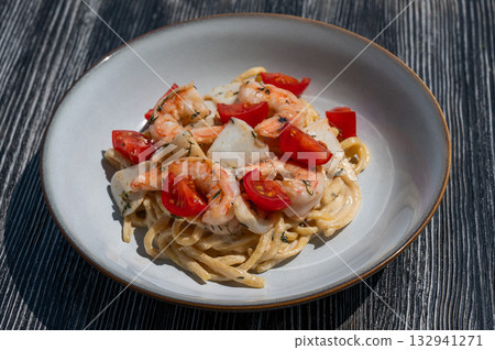 Pasta with shrimp and tomatoes.  132941271