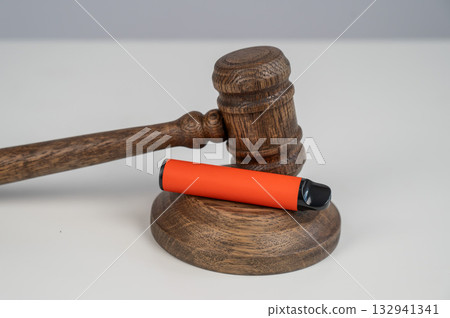 Judge's gavel and e-cigarette. Smoking ban. Tobacco heating systems. Judge's gavel and e-cigarette. Smoking ban. Tobacco heating systems. 132941341