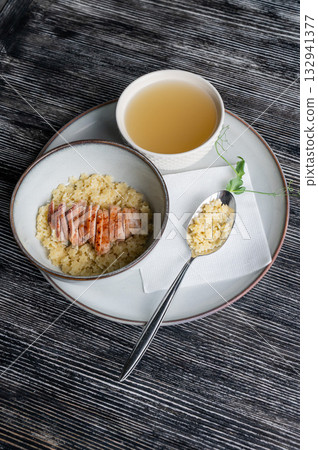 Chicken broth with noodles on a wooden table. Chicken broth with noodles on a wooden table. 132941377