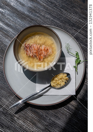 Chicken broth with noodles on a wooden table. Chicken broth with noodles on a wooden table. 132941378