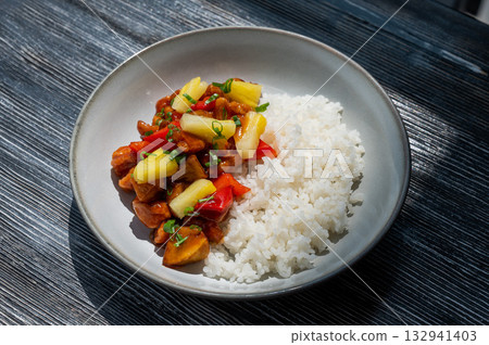Chicken with pineapple in teriyaki sauce with fried rice.  132941403