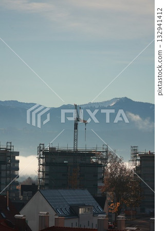 Construction site with snowy mountains backdrop 132941412