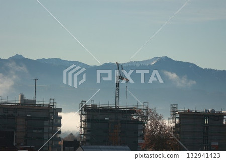 Construction Site in Valley with Snowy Mountains Construction Site in Valley with Snowy Mountains 132941423