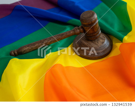 Judge's gavel and hammer on a rainbow flag. Judge's gavel and hammer on a rainbow flag. 132941539