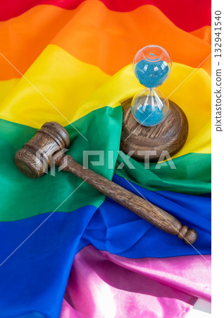 Judge's gavel and hourglass on rainbow flag.  132941540