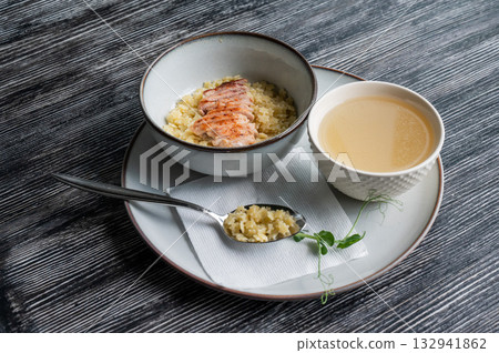 Chicken broth with noodles on a wooden table. Chicken broth with noodles on a wooden table. 132941862