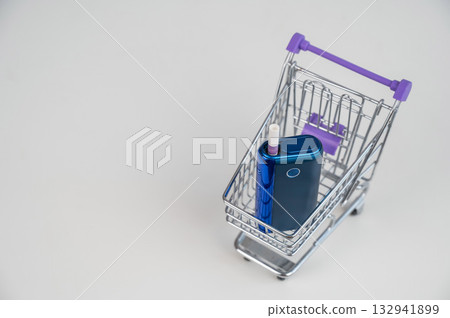 Electronic cigarette in a shopping cart. Tobacco heating system. Electronic cigarette in a shopping cart. Tobacco heating system. 132941899