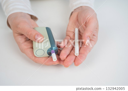 Woman holding regular and electronic cigarette on white background. Tobacco heating systems. 132942005