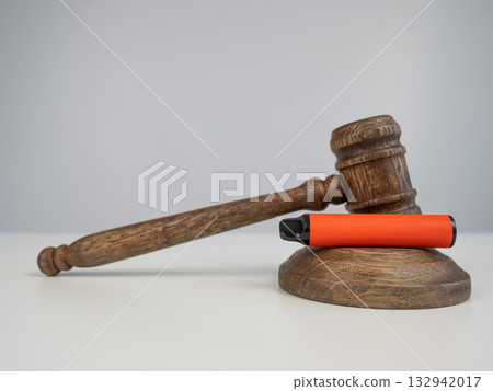 Judge's gavel and e-cigarette. Smoking ban. Tobacco heating systems.  132942017
