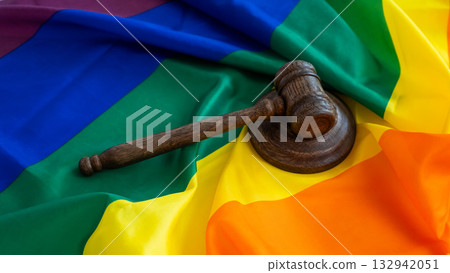 Judge's gavel and hammer on a rainbow flag. Judge's gavel and hammer on a rainbow flag. 132942051