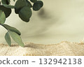 A branch of eucalyptus and a coarse linen cloth on a light background to demonstrate the product. 132942138