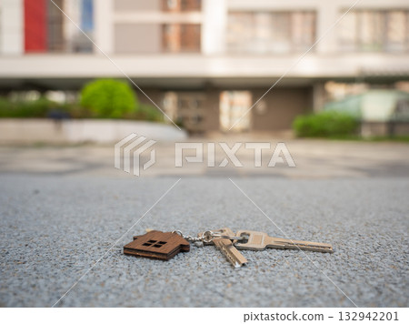 Keys with House Keychain Left on Paved Path.  132942201