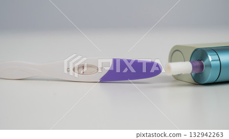Pregnancy test and electronic cigarette on white table. Pregnancy test and electronic cigarette on white table. 132942263