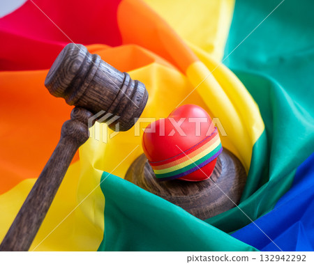 Judge's gavel and heart on rainbow flag.  132942292