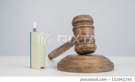 Judge's gavel and electronic cigarette. Smoking ban. Tobacco heating systems.  132942293