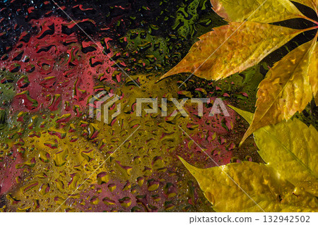 abstract background fall, glass drops autumn yellow leaves wet october weather 132942502