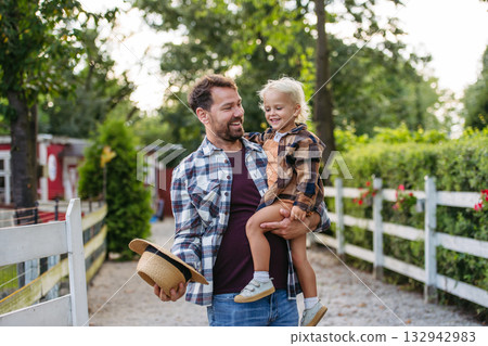Little boy and father on farm, standing on fence. Little boy and father on farm, standing on fence. 132942983