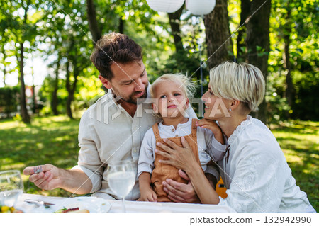 Potrait of young family during grill garden party. Potrait of young family during grill garden party. 132942990