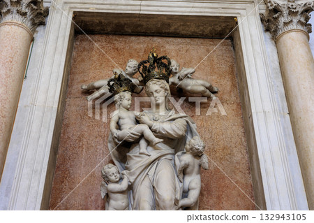 A sculpture of the Virgin Mary holding the baby Jesus 132943105