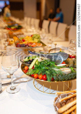 Luxury banquet table with vibrant vegetable platter and golden stand at elegant event 132943407