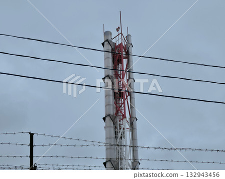 Industrial Chimney with Power Lines and Barbed Wire 132943456