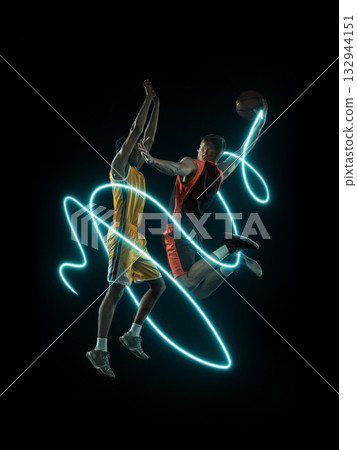 Two basketball players in mid-air duel surrounded by neon light trails 132944151