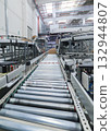 packing line in a logistics warehouse. conveyor belt in a modern production line 132944807