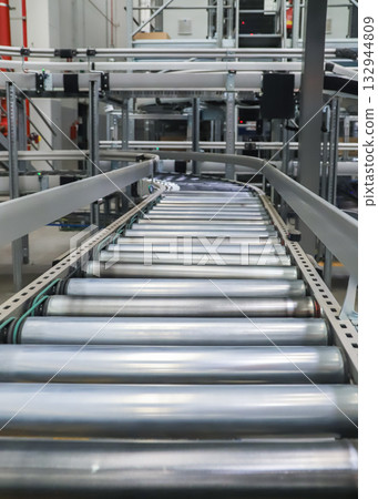 packing line in a logistics warehouse. conveyor belt in a modern production line packing line in a logistics warehouse. conveyor belt in a modern production line 132944809