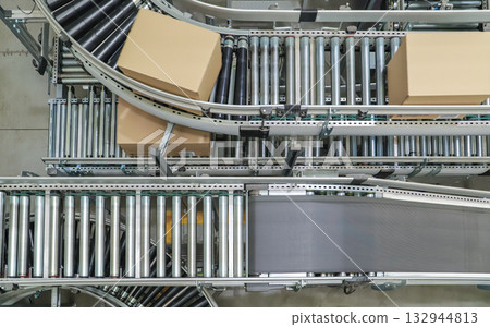 packing line in a logistics warehouse. conveyor belt in a modern production line packing line in a logistics warehouse. conveyor belt in a modern production line 132944813