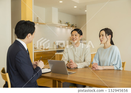 A salesman showing a model room A salesman showing a model room 132945656