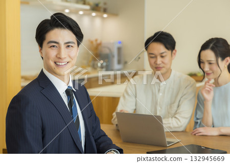A salesman showing a model room A salesman showing a model room 132945669