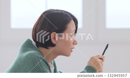 A woman watching a smartphone 132945957
