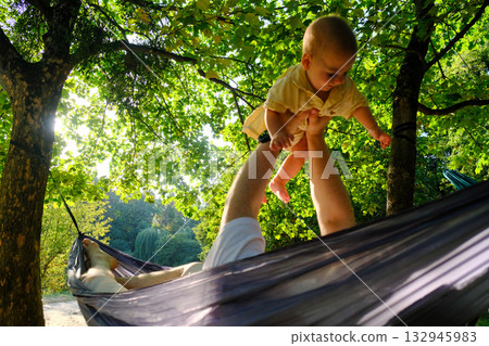 Parent and Baby Enjoying Hammock Time Outdoors 132945983