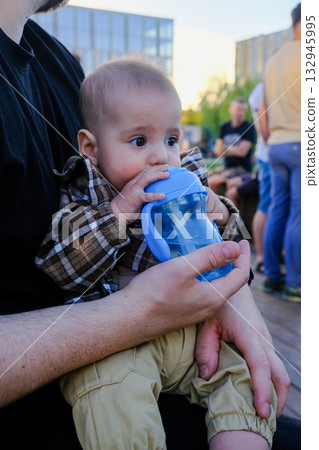 Baby in Stroller with Sippy Cup Outdoors Baby in Stroller with Sippy Cup Outdoors 132945995