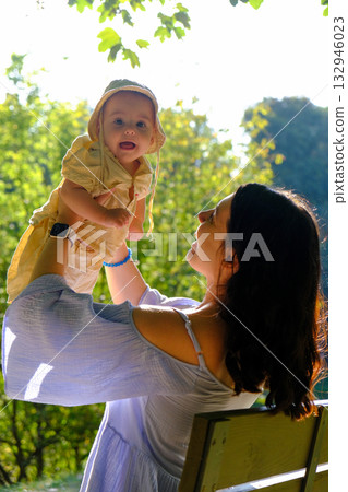 Mother and Baby Enjoying Sunny Day in Park 132946023
