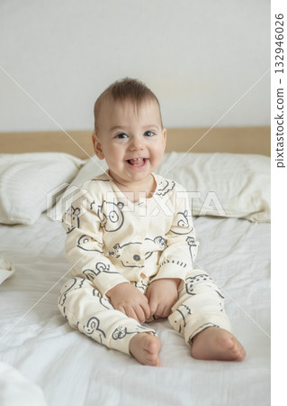Joyful baby in bear print pajamas 132946026