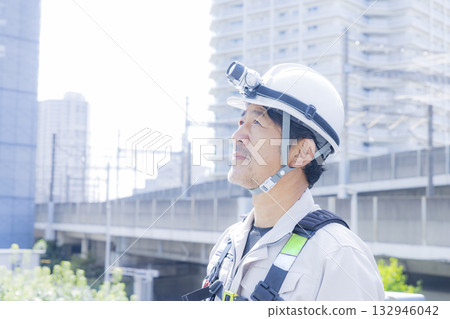 Worker wearing a full harness Worker wearing a full harness 132946042