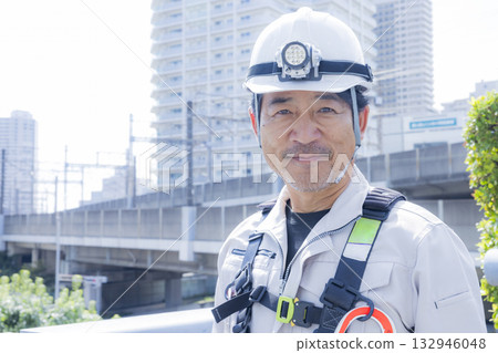Worker wearing a full harness 132946048