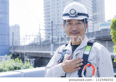 Worker wearing a full harness 132946050