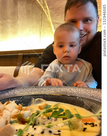 Father and baby enjoying a meal together 132946085